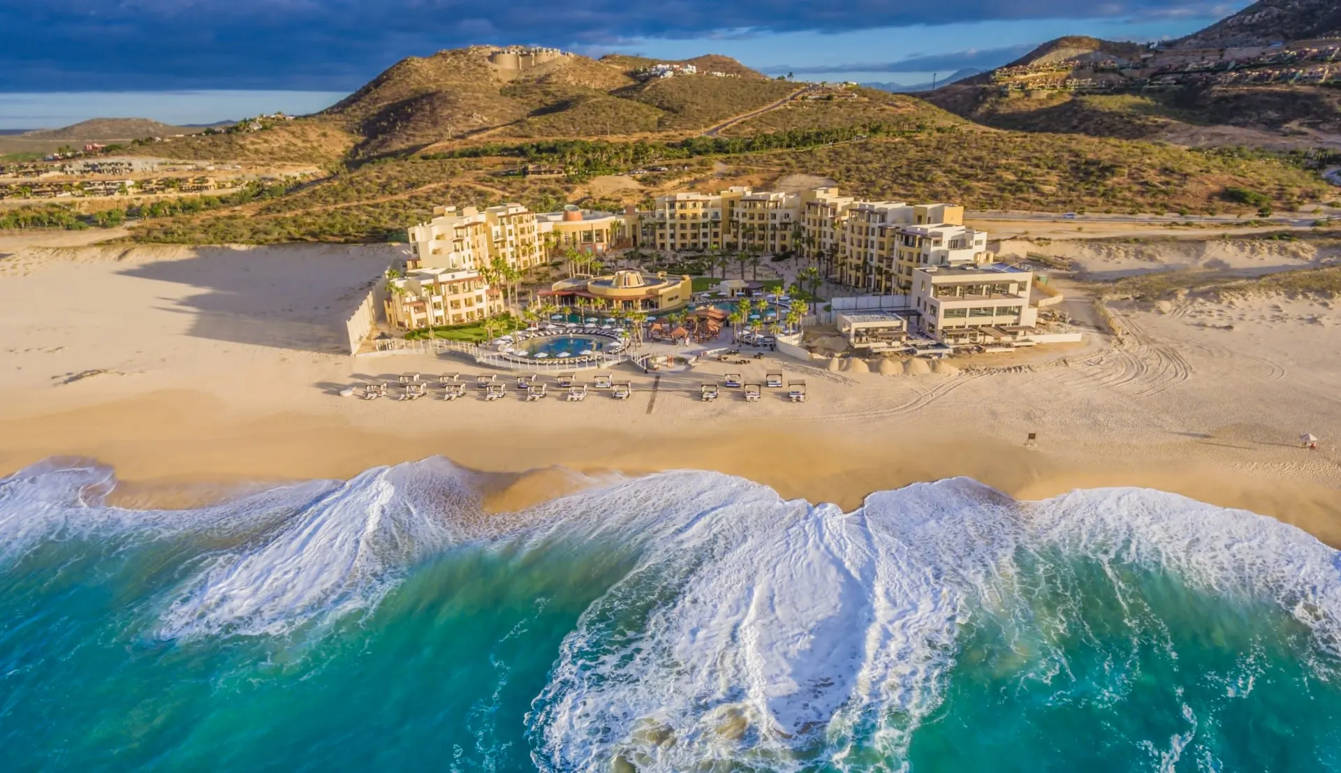 Aerial view of Pueblo Bonito Pacifica on its beach, with Pacific surf rolling in