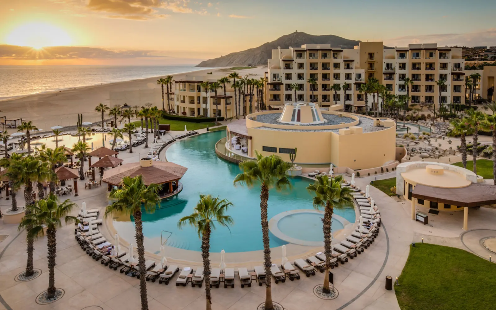 Palm-lined pools at Pueblo Bonito Pacifica with the resort behind